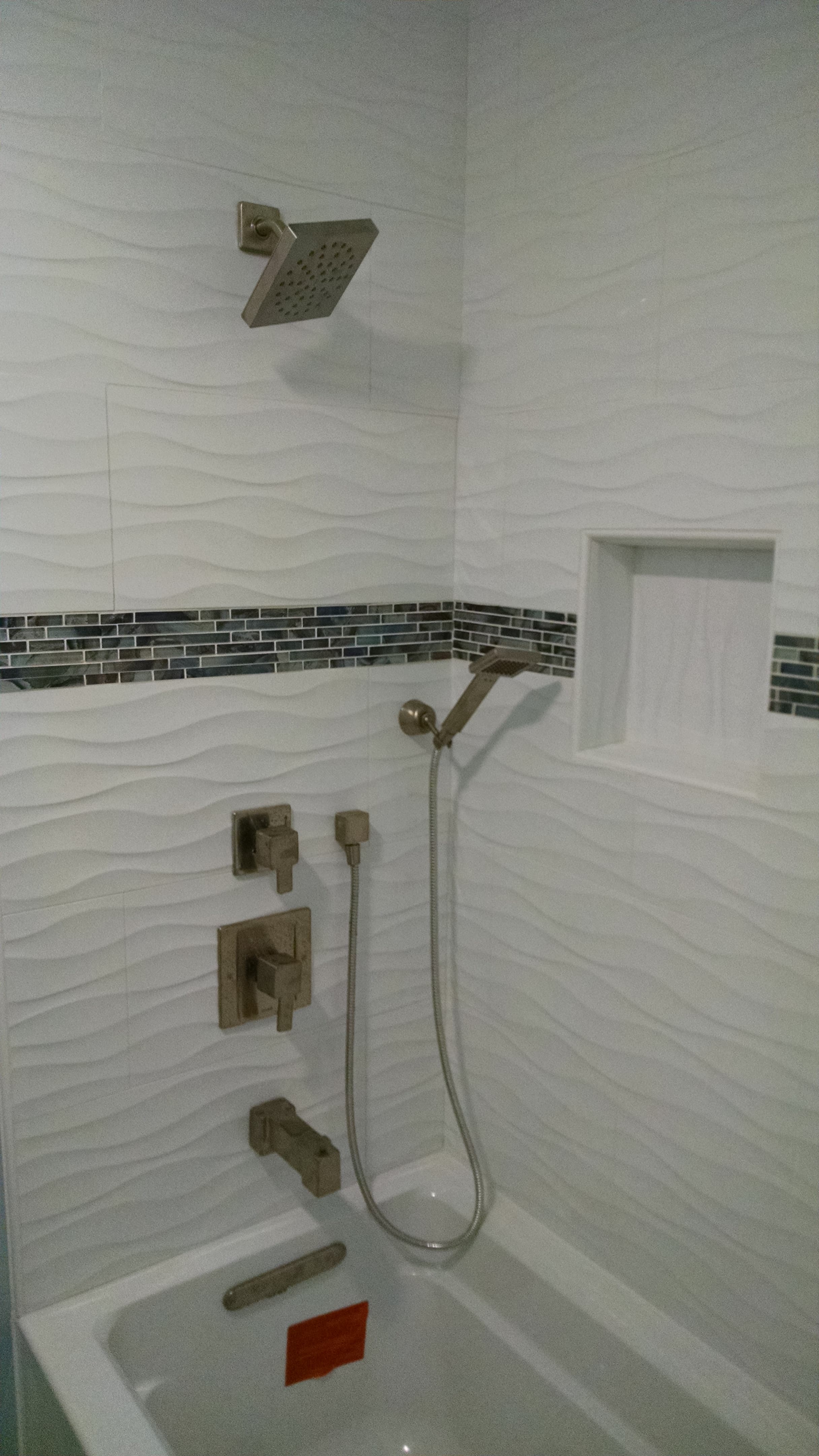Wavy Tile Tub-Shower with Blue Mosaic — bathroom remodel in Encinitas